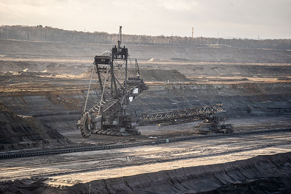 A wide shot of a crane and a metal structure in a mining site